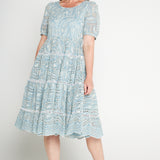 Model wearing Eloise Dress in blue lace – waist-accentuating, adjustable drawstring fit-and-flare style