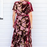 Back view of Violet Dress in blossom wine velvet – tie belt and flowing skirt