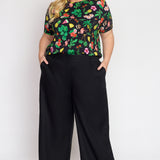 Model wearing Bianca Pant in black – high-rise waist and relaxed straight silhouette