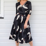 Model wearing Cleo Dress in black Poetry in Motion print – nipped waist and twirly skirt