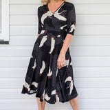 Model wearing Cleo Dress in black Poetry in Motion print – nipped waist and twirly skirt
