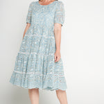 Model wearing Eloise Dress in blue lace – waist-accentuating, adjustable drawstring fit-and-flare style