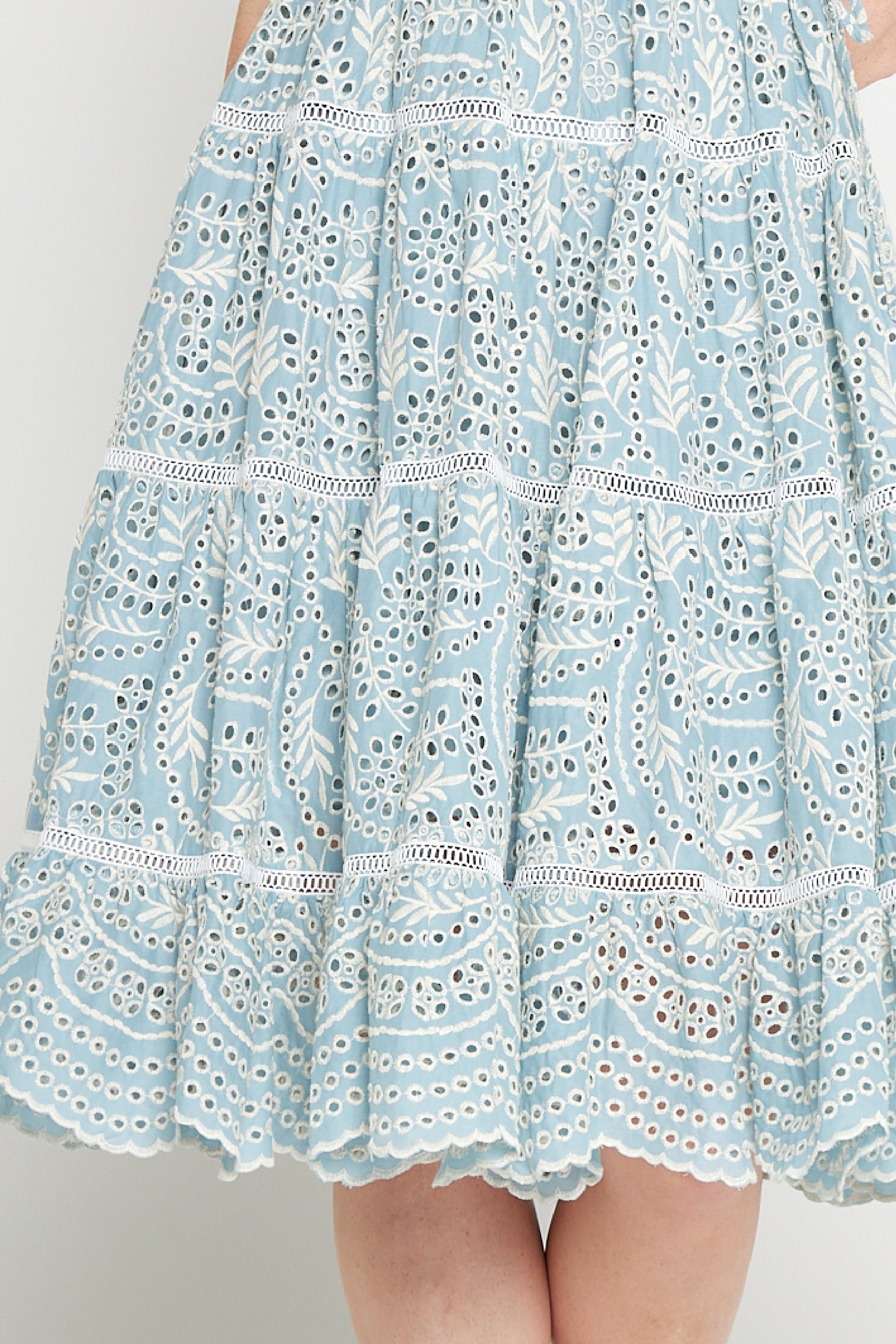 Close-up of embroidered cotton lace and ladder trim on Eloise Dress in blue lace