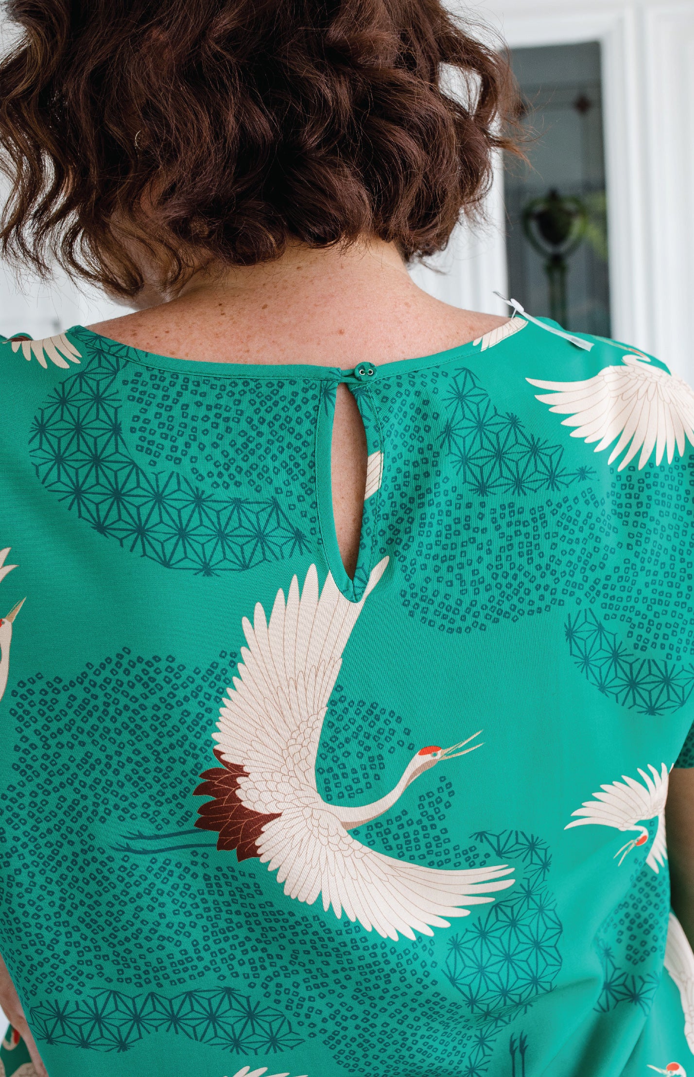 Button and loop neck opening on Poetry in Motion Green Poppy Top