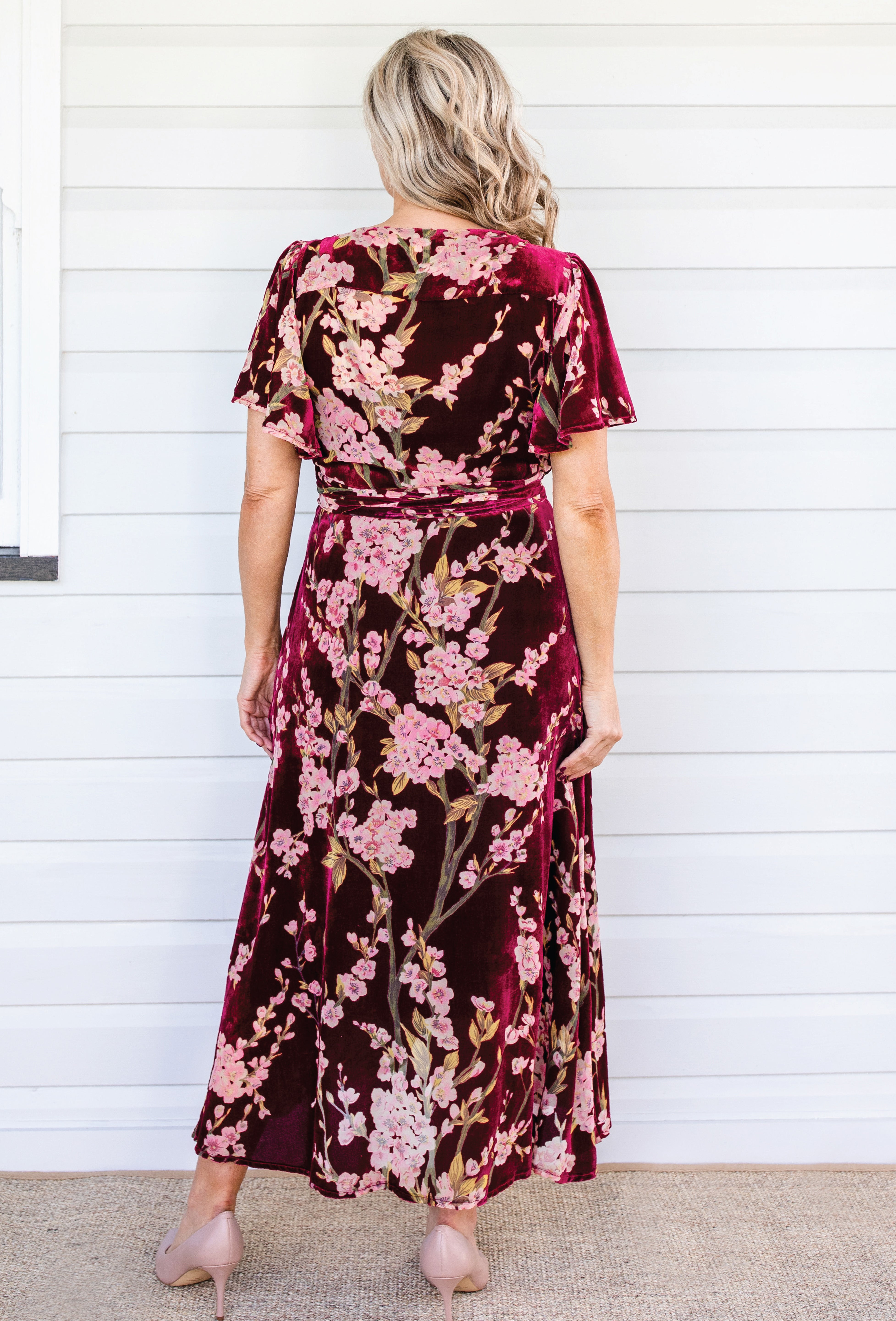 Back view of Violet Dress in blossom wine velvet – tie belt and flowing skirt