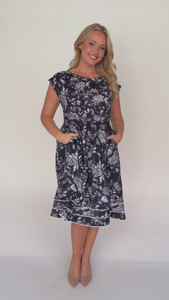 Holiday Dress by Maiocchi, featuring a fit & flare style, pockets and a white scollop trim at the hem.