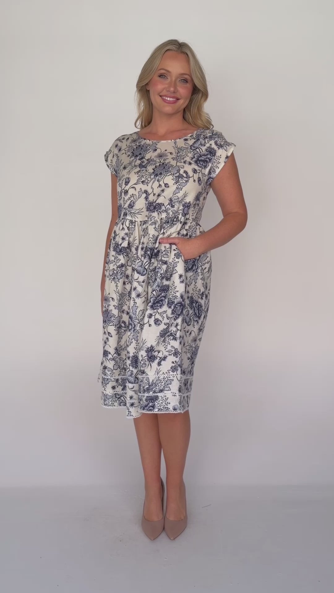 Holiday Dress by Maiocchi, featuring a fit & flare style, pockets and a white scollop trim at the hem.