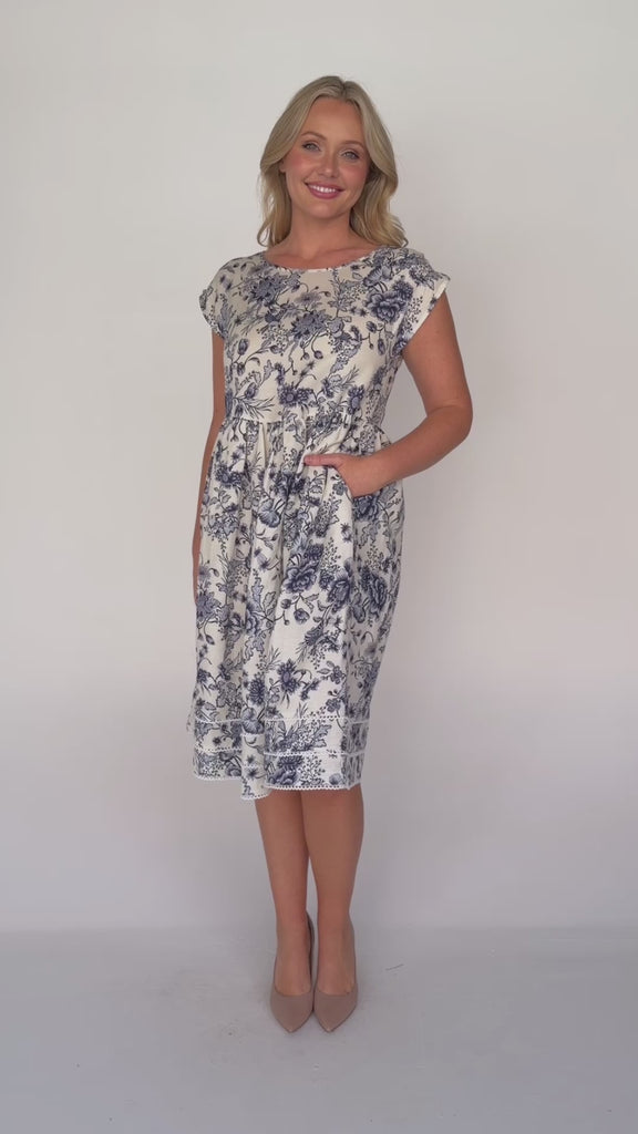 Holiday Dress by Maiocchi, featuring a fit & flare style, pockets and a white scollop trim at the hem.