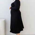 Side view of plain black Must Have Skirt – smooth drape and slim fit at waist