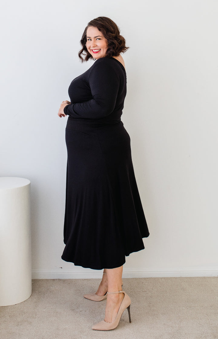 Side view of plain black Must Have Skirt – smooth drape and slim fit at waist